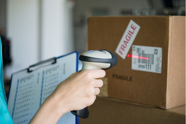 A team member scanning a shipping label on a packed order